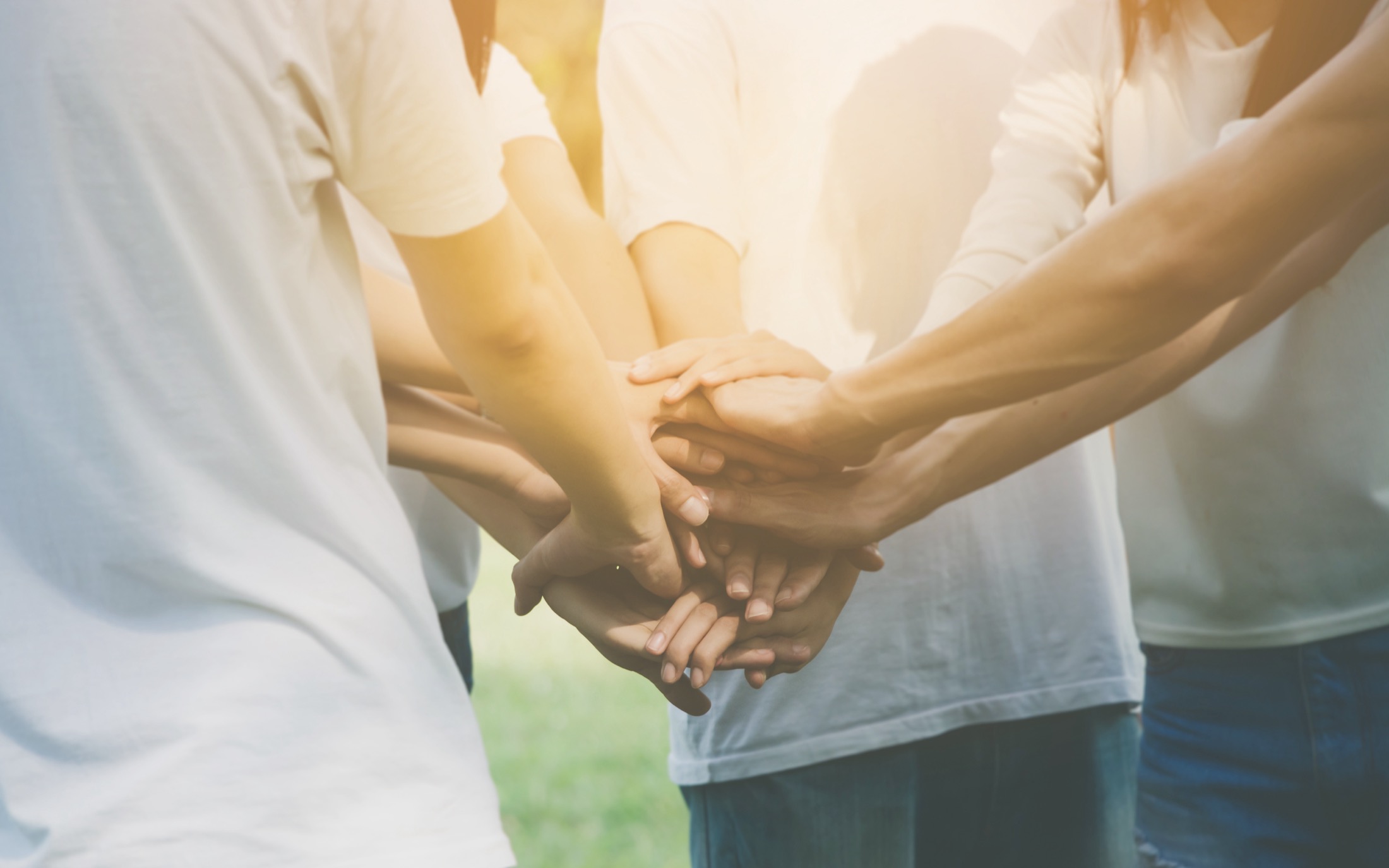 Hands of a group coming together to show teamwork
