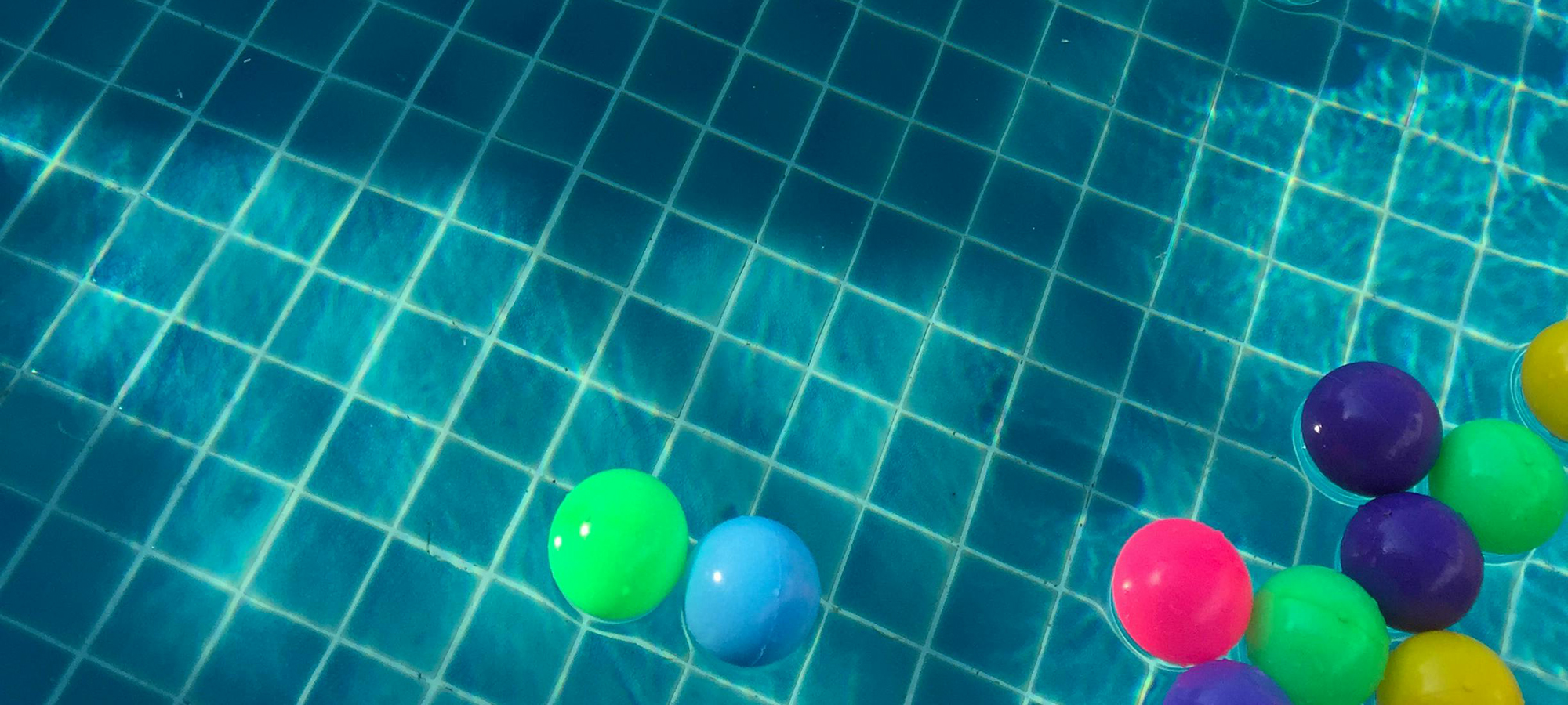Colorful balls floating in a swimming pool