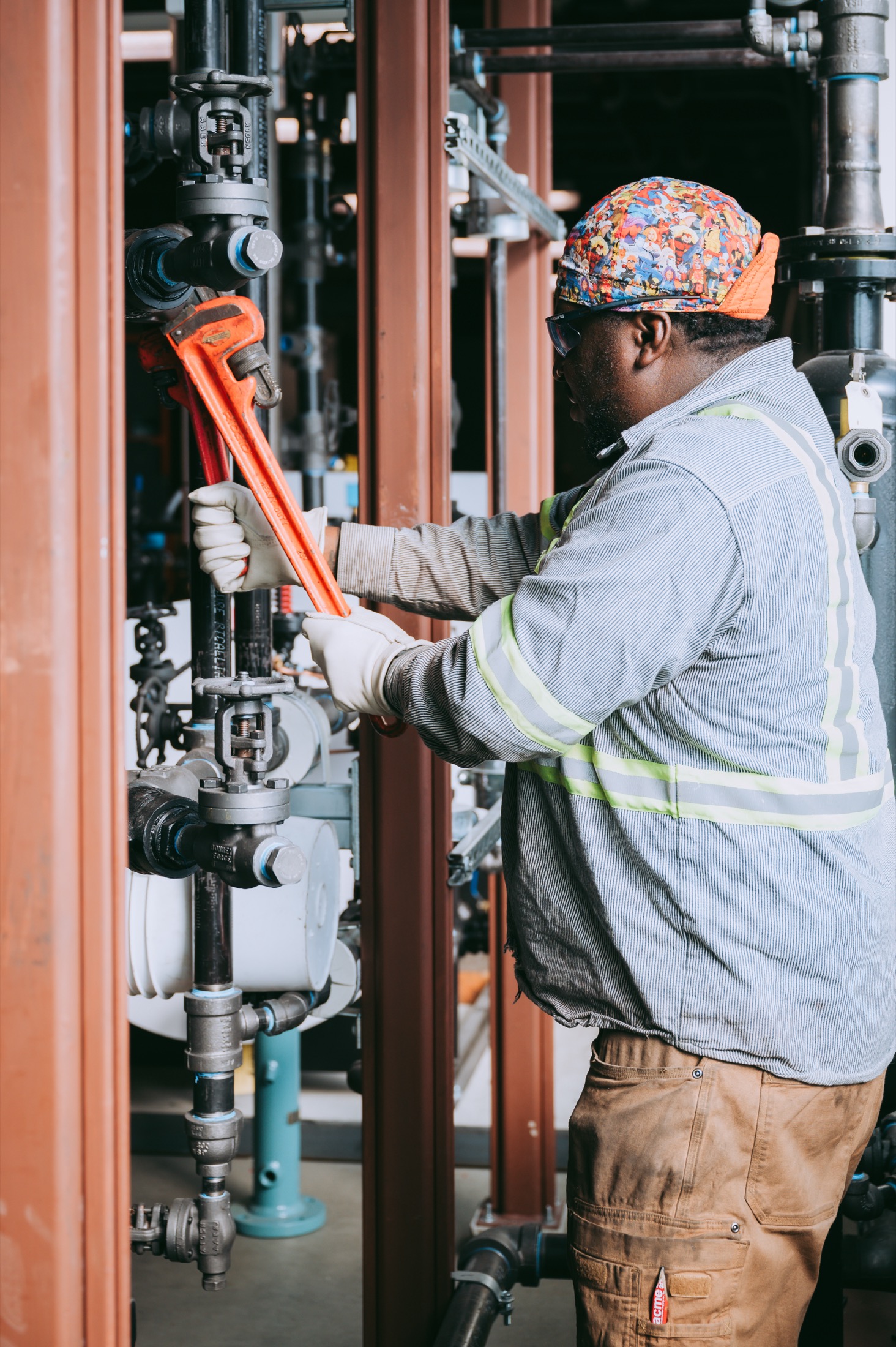 Pipe-fitter using a wrench to tighten fittings